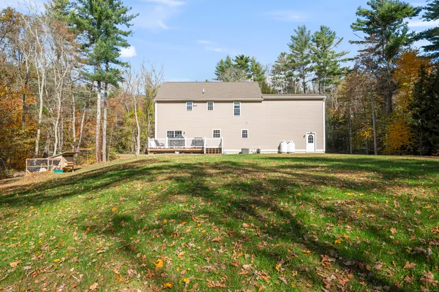 a backyard of a house with table and chairs