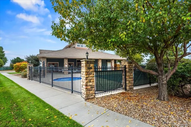 a view of a house with a swimming pool and sitting area