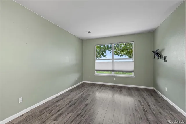 a view of a kitchen with a sink and a refrigerator