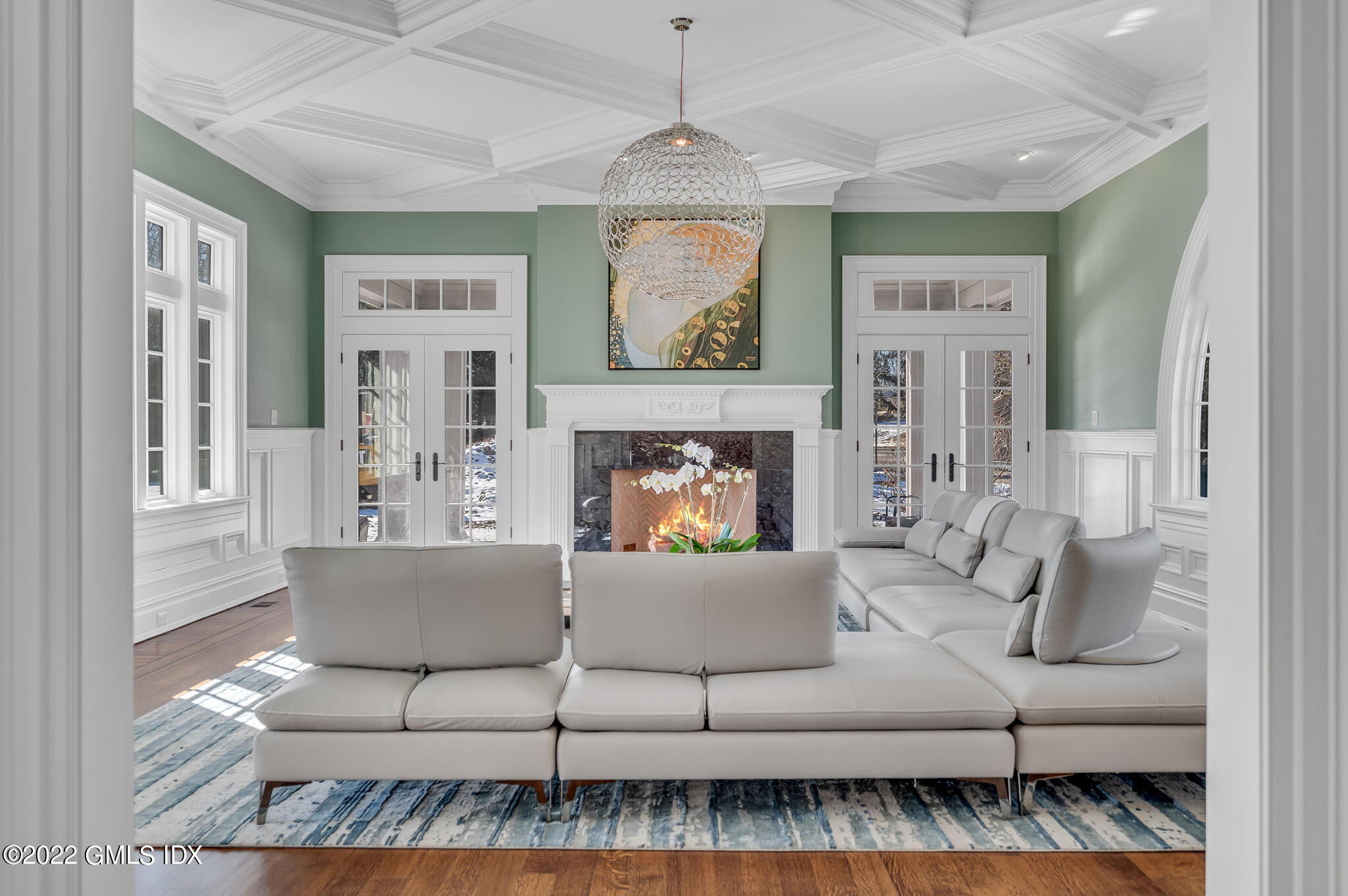 504 North Street Greenwich, CT 06830 - Photo 8 of 25 a living room with furniture a fireplace and a chandelier