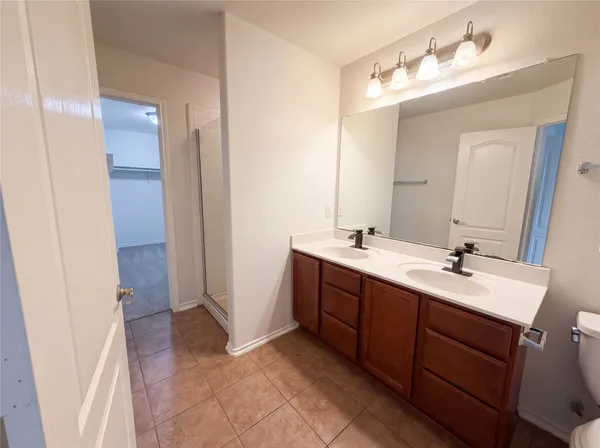 a bathroom with a double vanity sink mirror and double