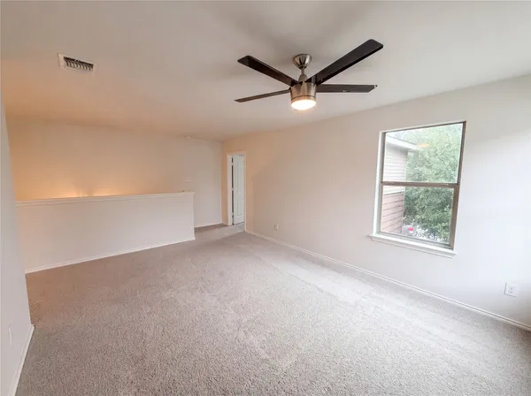 a view of a big room with closet and windows