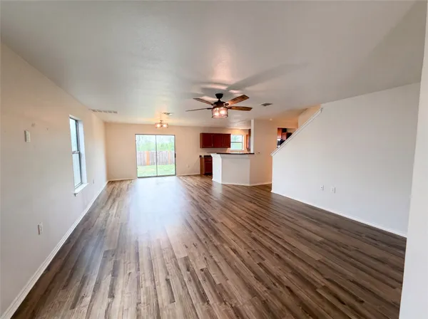 wooden floor in an empty room with a window