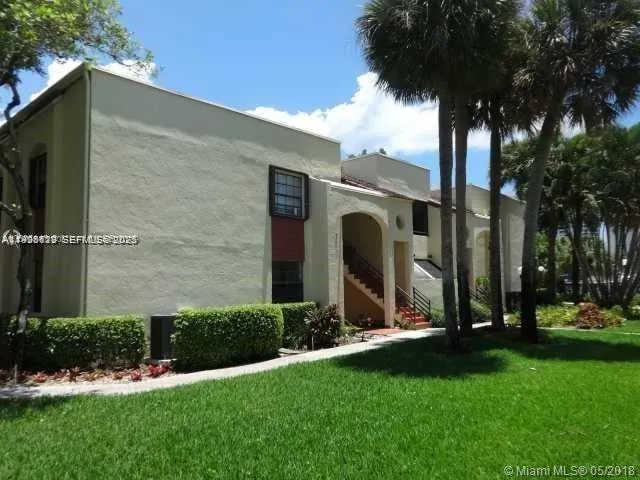 a view of a back yard with patio and plants
