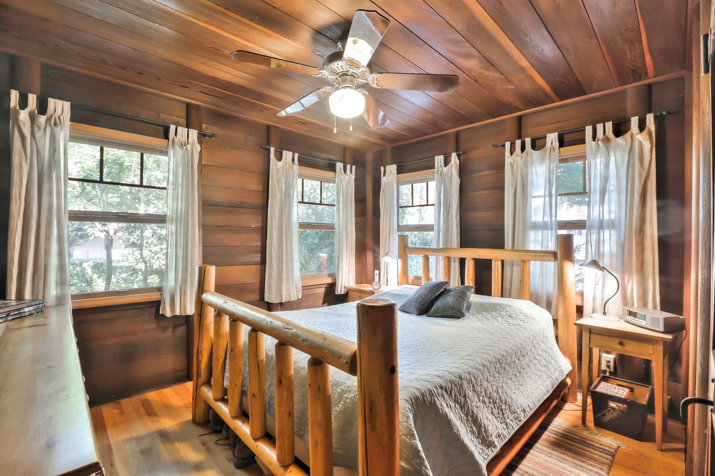300 Riverside Avenue Ben Lomond, CA 95005 - Photo 11 of 22 a bedroom with furniture and large windows