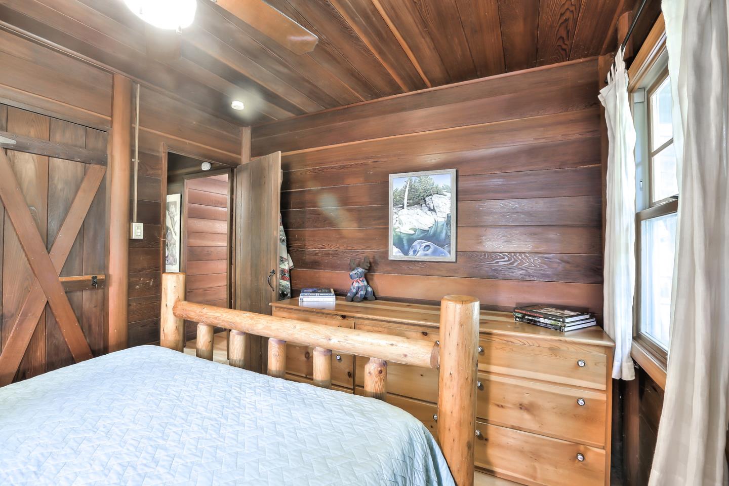 300 Riverside Avenue Ben Lomond, CA 95005 - Photo 12 of 22 a bedroom with a bed a dresser and a window