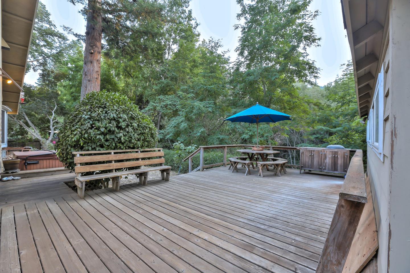 300 Riverside Avenue Ben Lomond, CA 95005 - Photo 17 of 22 a view of backyard with table and chairs under an umbrella with wooden floor