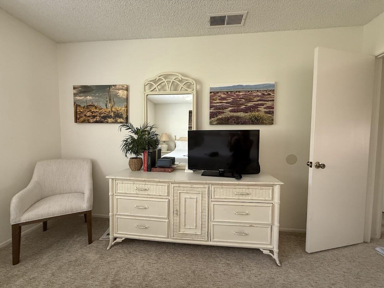72822 Tony Trabert Lane Palm Desert, CA 92260 - Photo 16 of 23 a living room with furniture and a flat screen tv