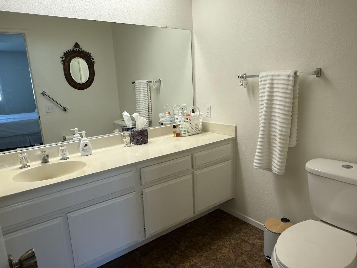72822 Tony Trabert Lane Palm Desert, CA 92260 - Photo 18 of 23 a bathroom with a granite countertop sink mirror vanity and toilet