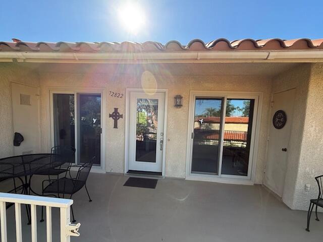 72822 Tony Trabert Lane Palm Desert, CA 92260 - Photo 3 of 23 a view of a house with a porch
