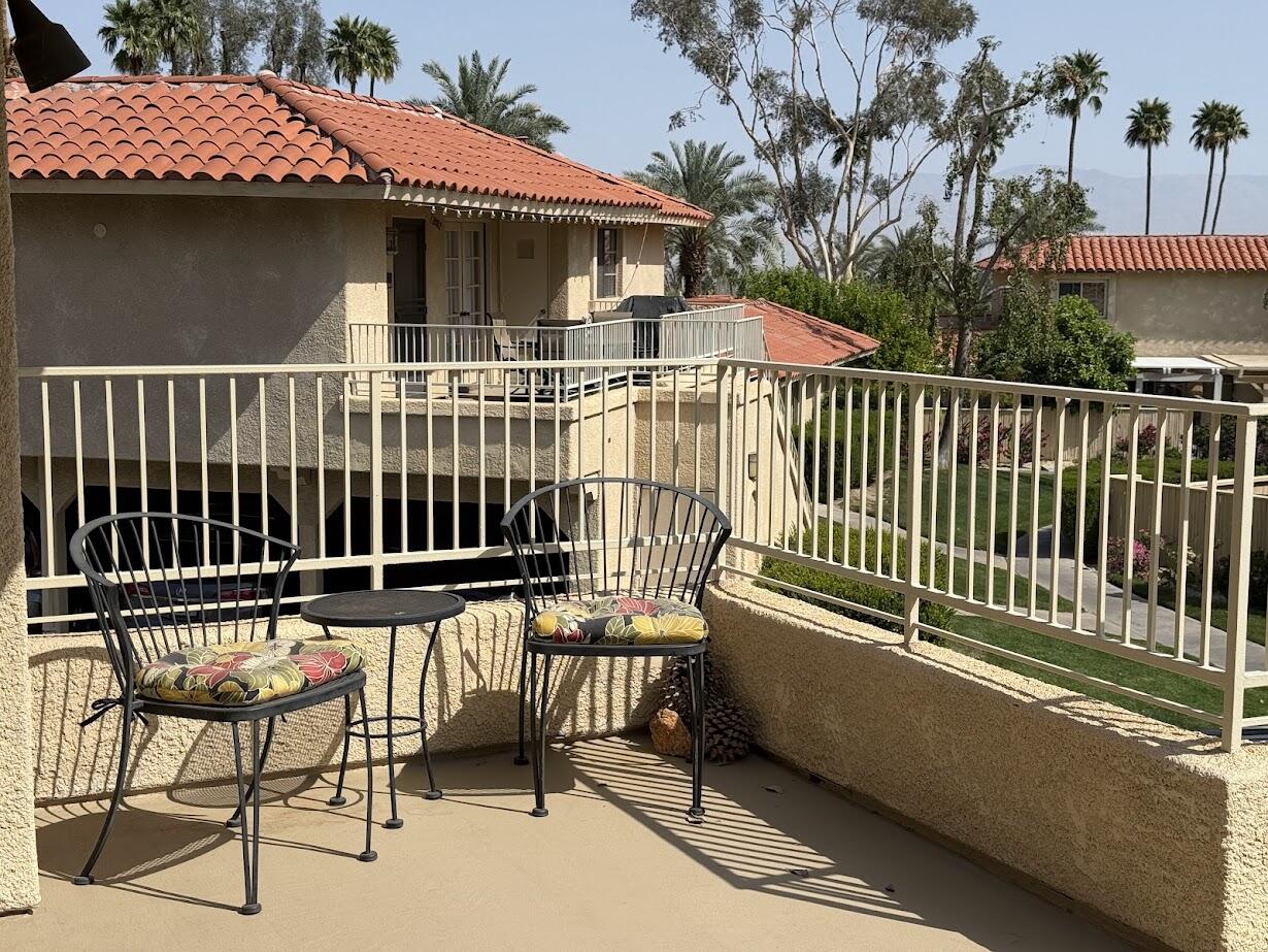 72822 Tony Trabert Lane Palm Desert, CA 92260 - Photo 5 of 23 a balcony with table and chairs