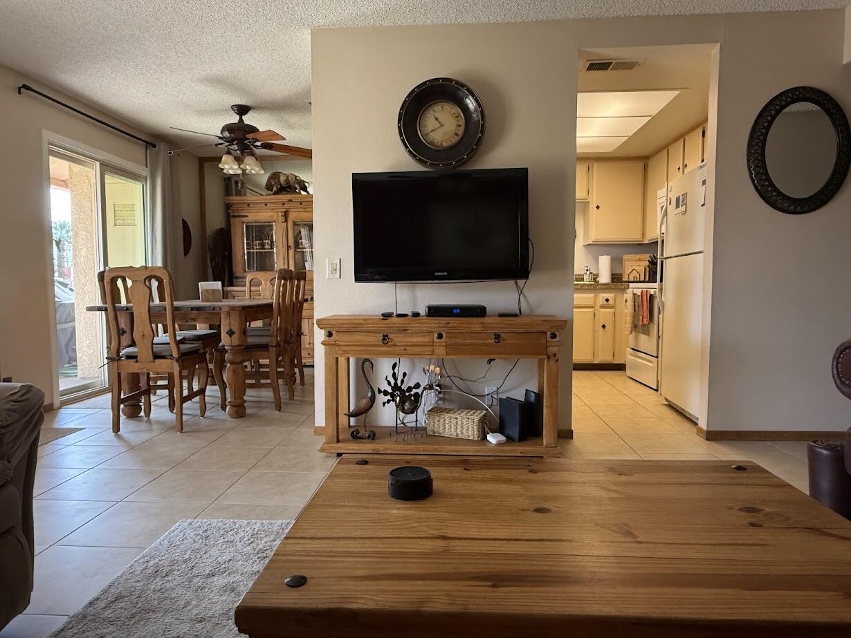 72822 Tony Trabert Lane Palm Desert, CA 92260 - Photo 9 of 23 a living room with furniture and a flat screen tv