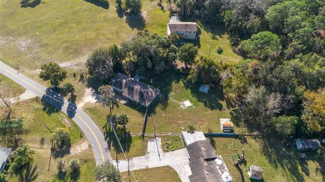an aerial view of a house with a yard