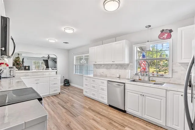a kitchen with sink cabinets and window
