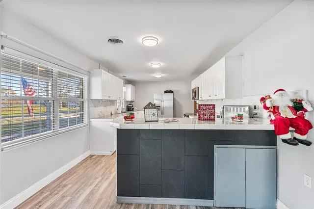 a open kitchen with a sink cabinets and window