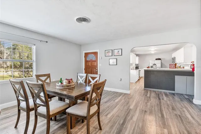 a view of a dining room with furniture and wooden floor