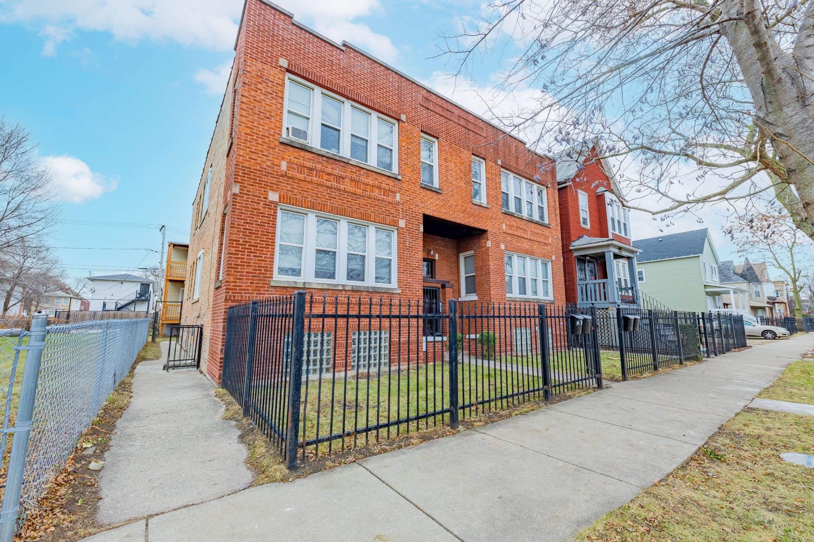 a view of a brick building next to a yard