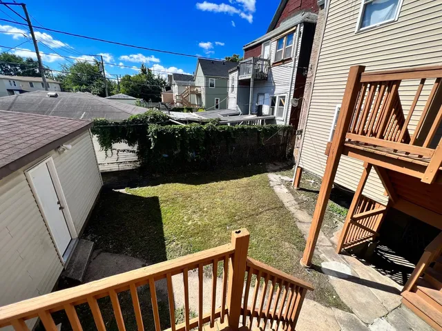 a view of a balcony with furniture and a yard