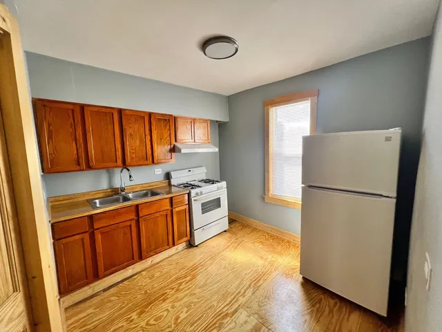 a kitchen with stainless steel appliances a refrigerator and a sink