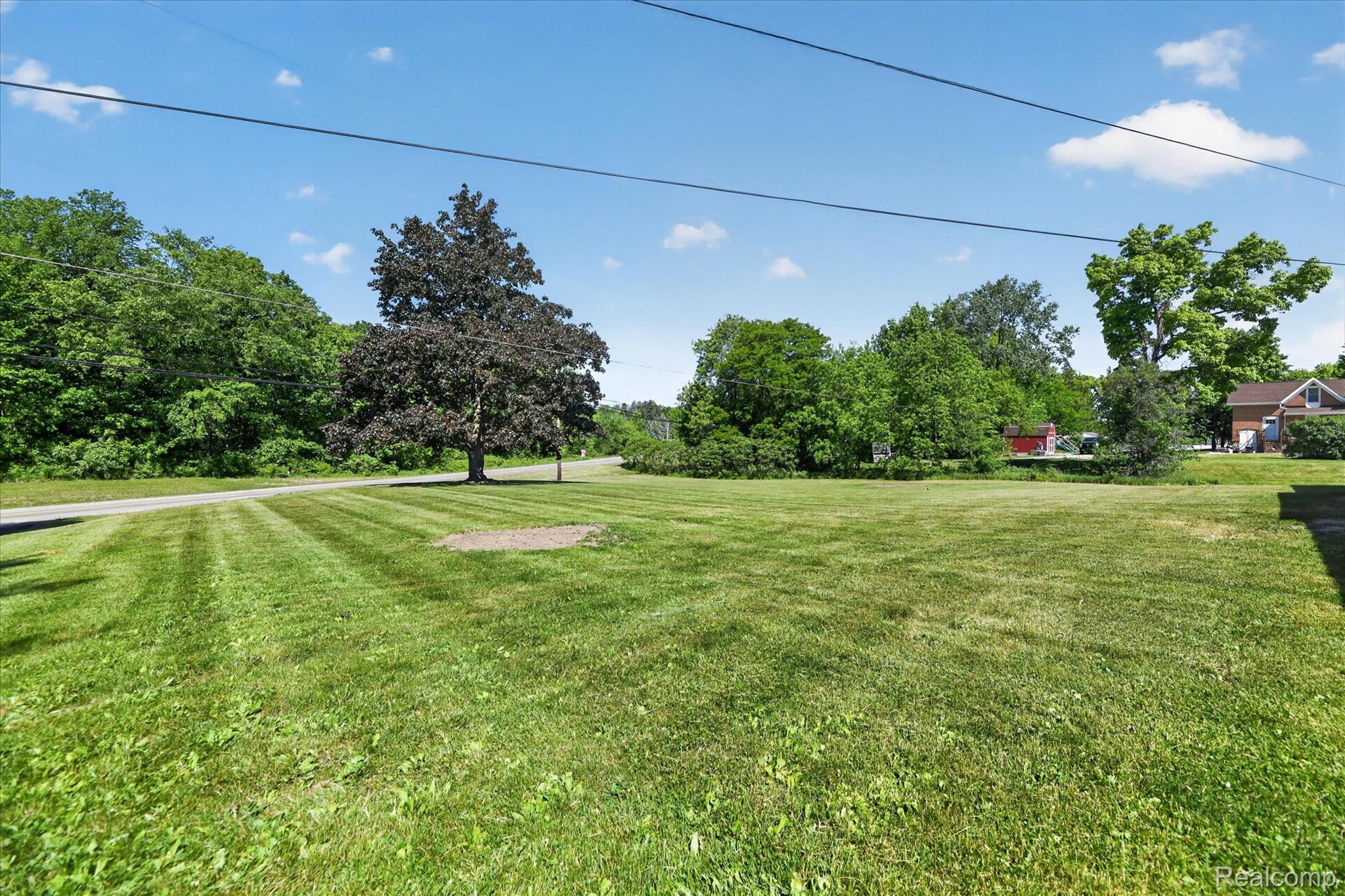 2250 Montague Road Davison, MI 48423 - Photo 44 of 45 Expansive green lawn with a mature tree
