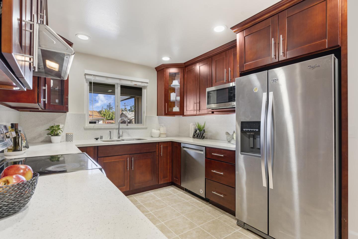 5601 Drysdale Drive San Jose, CA 95124 - Photo 5 of 26 a kitchen with stainless steel appliances granite countertop a refrigerator a sink dishwasher a stove with wooden cabinets and floor