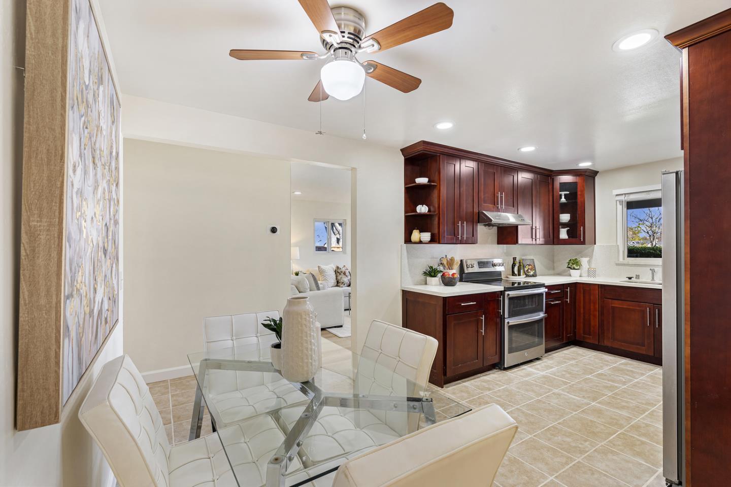 5601 Drysdale Drive San Jose, CA 95124 - Photo 6 of 26 a large kitchen with stainless steel appliances kitchen island granite countertop a table and chairs in it