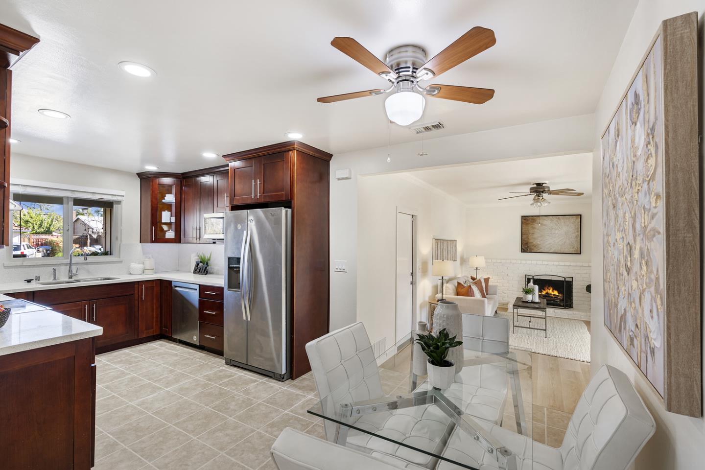 5601 Drysdale Drive San Jose, CA 95124 - Photo 7 of 26 a kitchen with stainless steel appliances kitchen island granite countertop a refrigerator a stove a sink a dining table and chairs with wooden floor