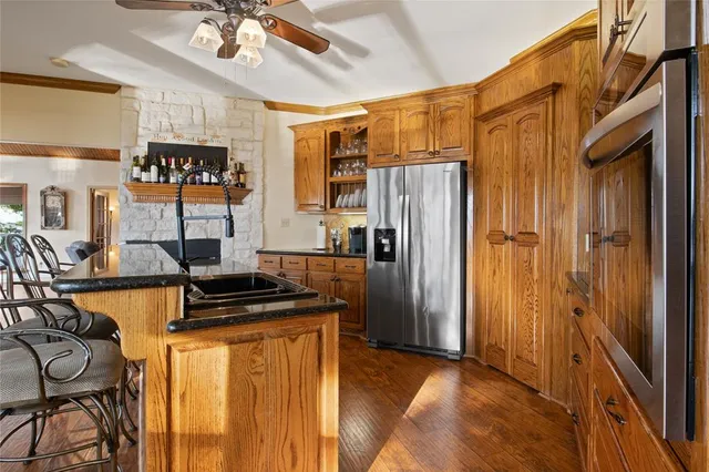 a kitchen with stainless steel appliances granite countertop a refrigerator and a sink