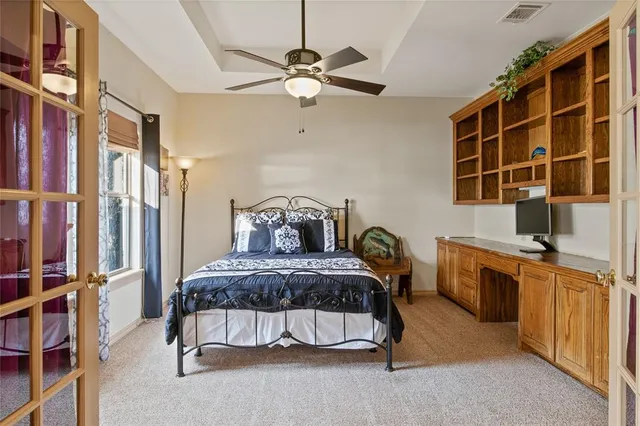 a bedroom with a bed and a chandelier