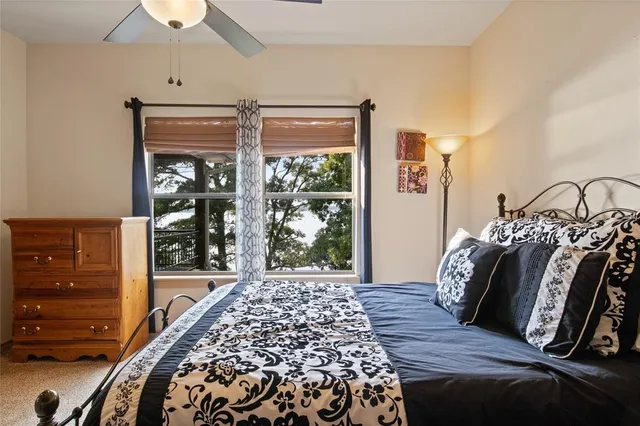 a view of a bedroom with wooden floor and windows