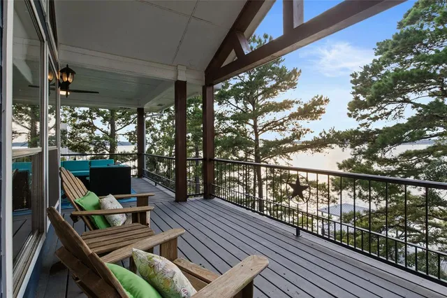 a front view of a house with a garden and tree