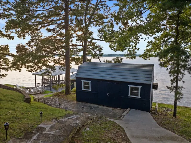 a backyard of a house with table and chairs