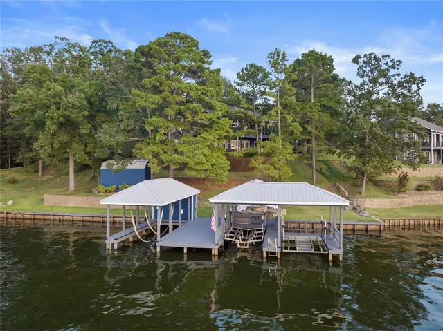 a table and chairs sitting in the middle of a lake