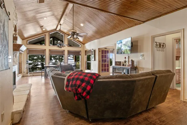 a living room with furniture and a view of kitchen