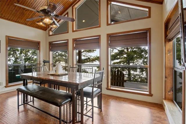 a dining room with furniture a chandelier and wooden floor
