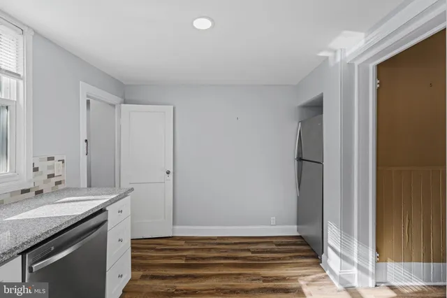 a kitchen with sink stove and microwave