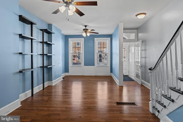 a view of an entryway with wooden floor and a ceiling fan
