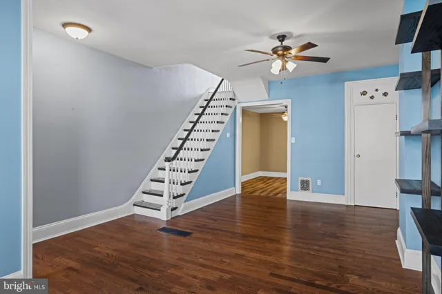 a view of an entryway with wooden floor and stairs