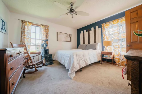 a bed room with a bed and a window