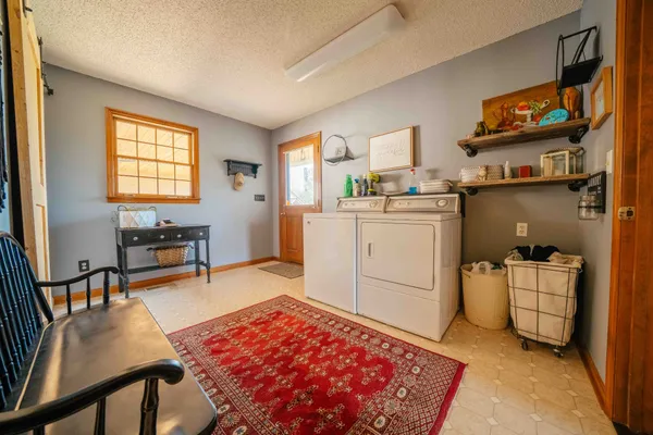 a room with furniture a rug and a window