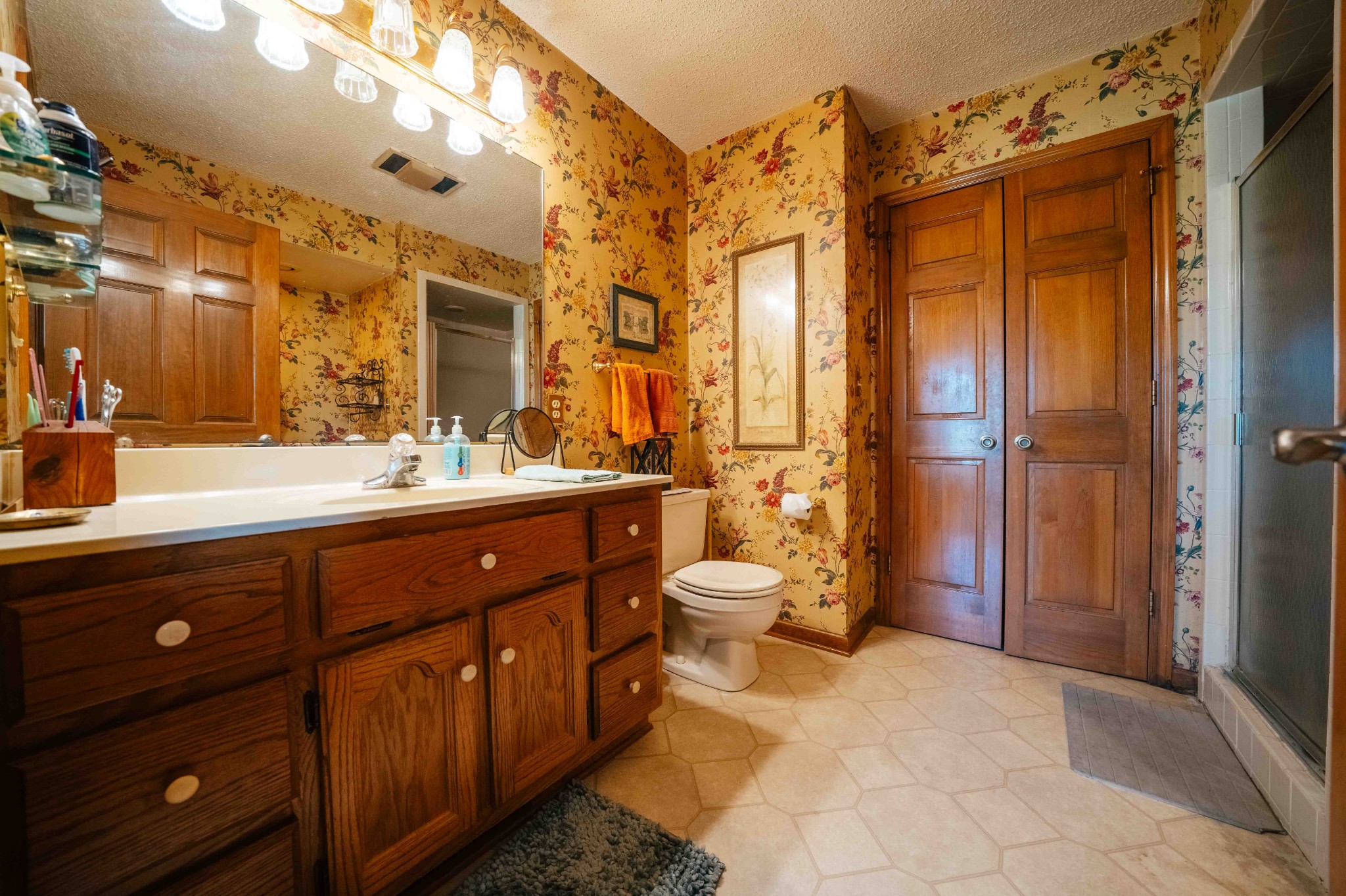 194 Al Roman Road Pulaski, TN 38478 - Photo 14 of 15 a spacious bathroom with a double vanity sink a large mirror and a shower