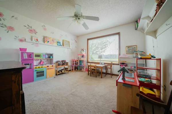a children room with furniture and a window