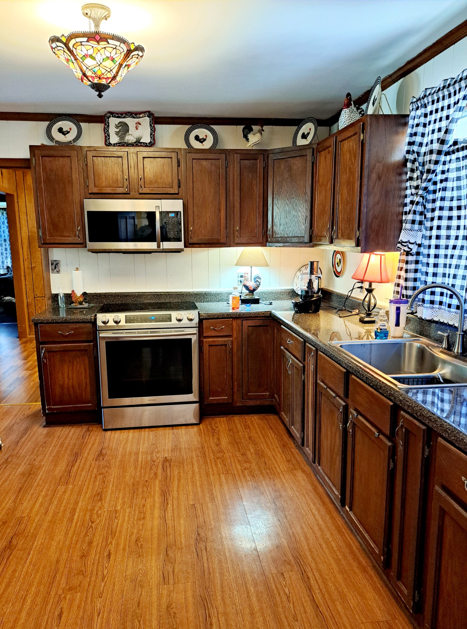 8317 Gordon Lane Hermitage, TN 37076 - Photo 17 of 23 a kitchen with stainless steel appliances wooden cabinets and a wooden floor