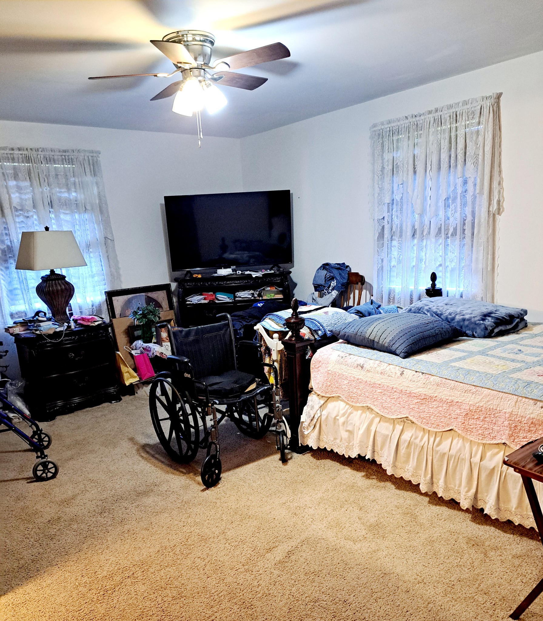 8317 Gordon Lane Hermitage, TN 37076 - Photo 21 of 23 a bedroom with bed a flat tv screen and a dresser with the shoe rack