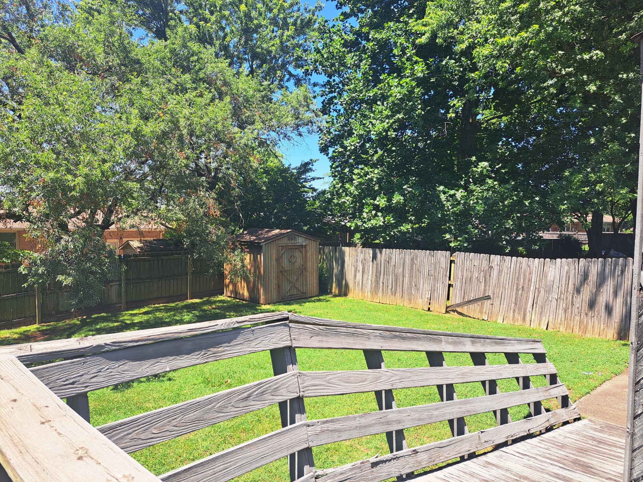 8317 Gordon Lane Hermitage, TN 37076 - Photo 8 of 23 a view of a backyard with a wooden fence