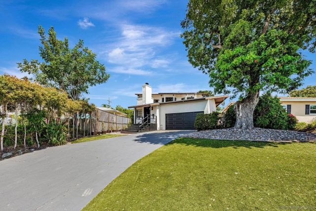 a view of a house with pool and a yard
