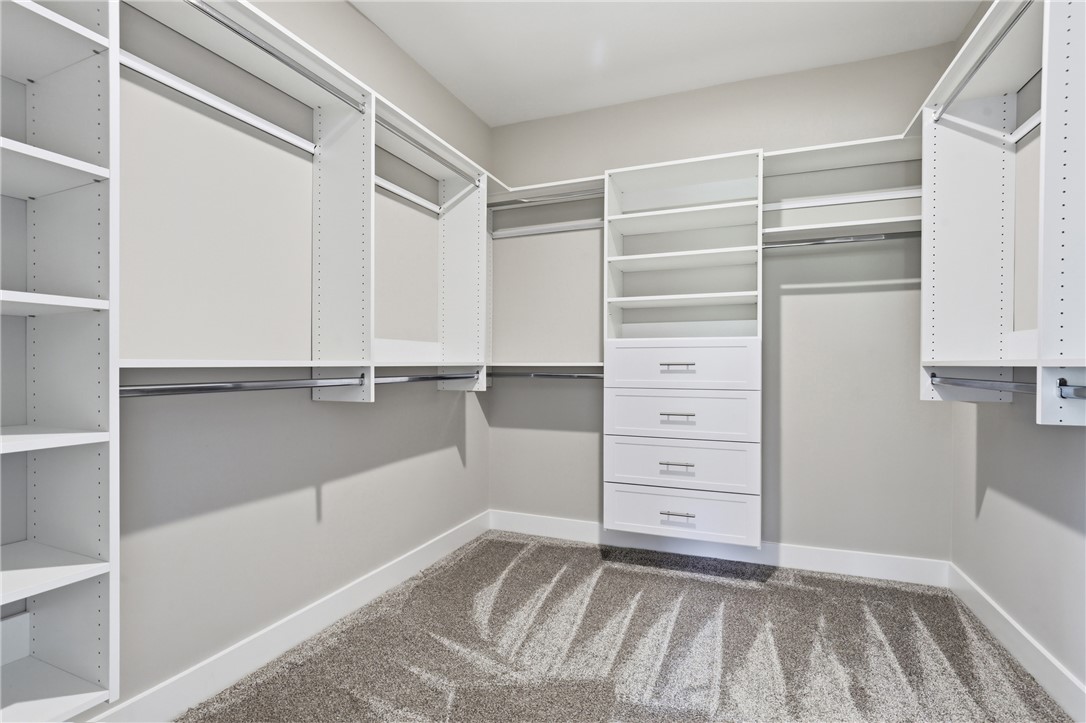 736 Stewart Gin Road Liberty, SC 29657 - Photo 24 of 50 This spacious walk-in closet offers ample storage with built-in shelving and convenient drawer units.