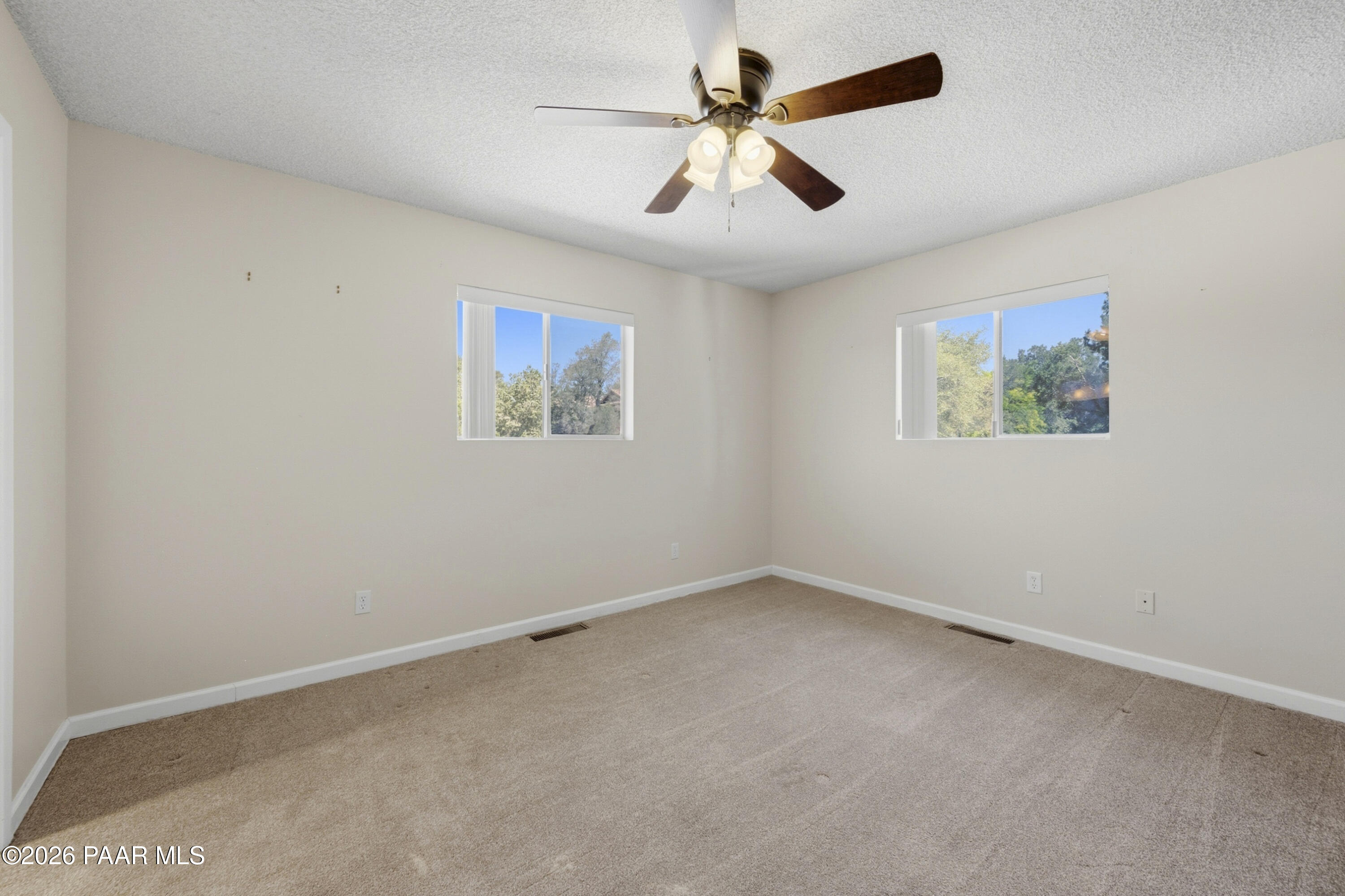 1775 Grandview Road Prescott, AZ 86305 - Photo 17 of 42 an empty room with a window and a fan