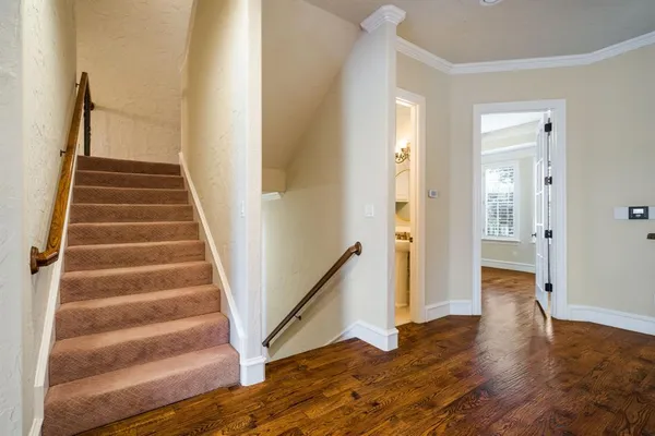 a view of an entryway with wooden floor and staircase