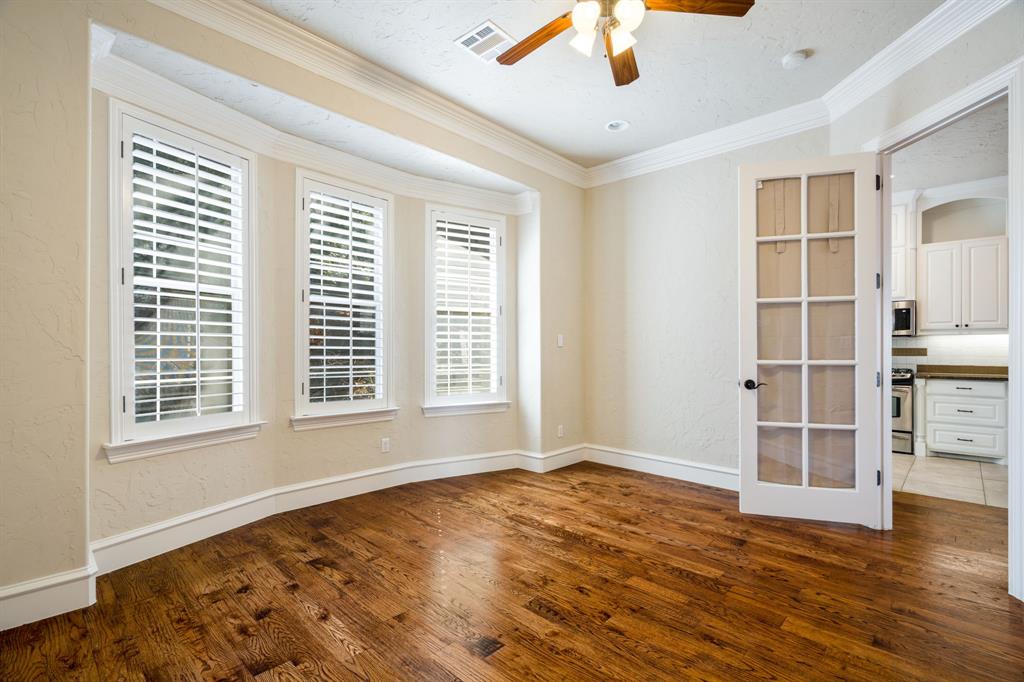 554 Rockingham Drive Irving, TX 75063 - Photo 14 of 34 a view of an empty room with a window and wooden floor